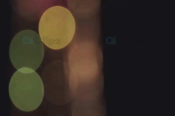 Soft Green and Yellow Bokeh Lights on Dark Background for Elegant Motion Graphics