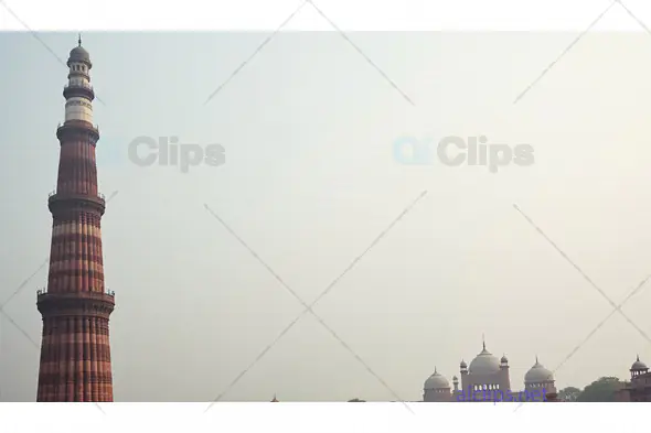 Qutub Minar and Historic Domes in Foggy Delhi Skyline