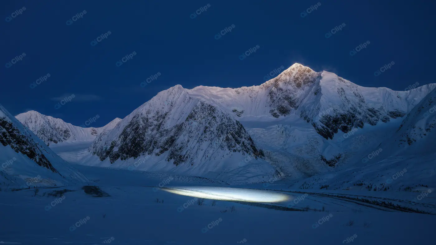 Snowy Mountain Range at Twilight with Dramatic Light Beam