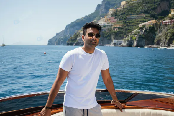 Man Relaxing on a Luxury Boat with Coastal View