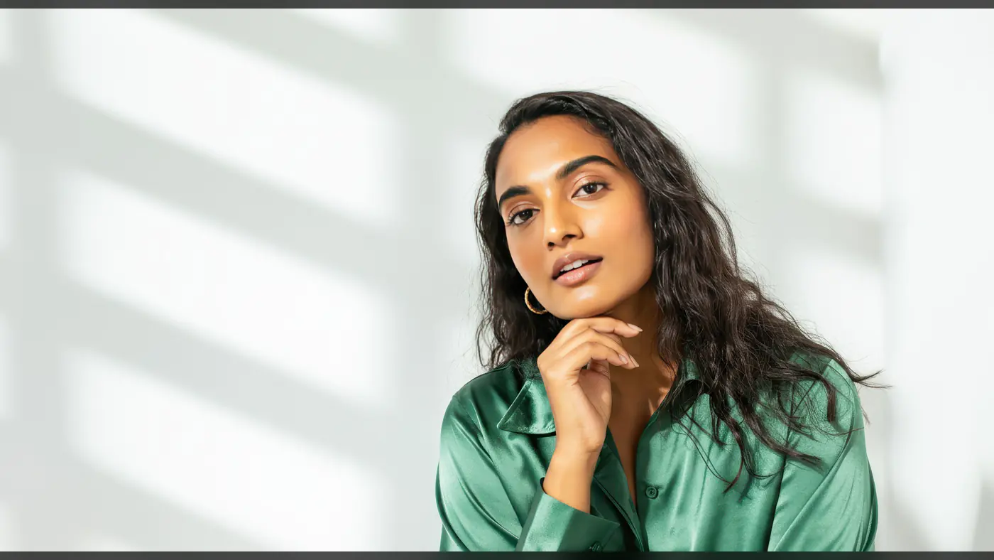 Confident Woman in Green Satin Shirt with Natural Light