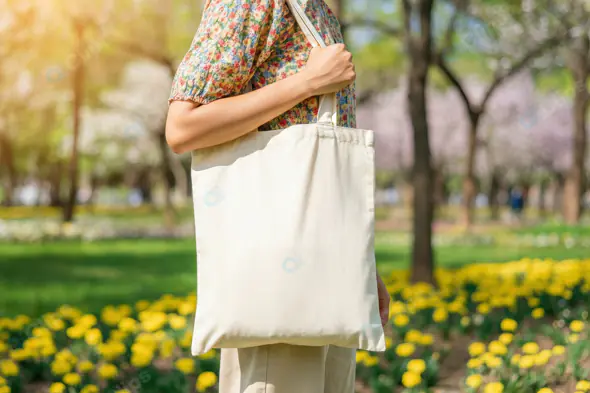 Stylish Woman Carrying Eco-Friendly Canvas Tote Bag in Park