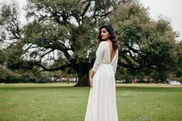 Elegant Woman in Backless White Dress Outdoors