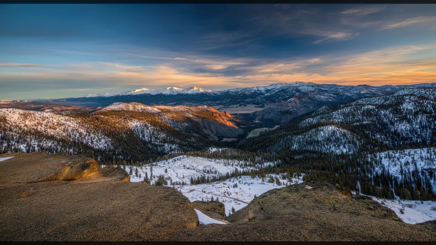 Breathtaking Snowy Mountain Range Panorama at Sunset
