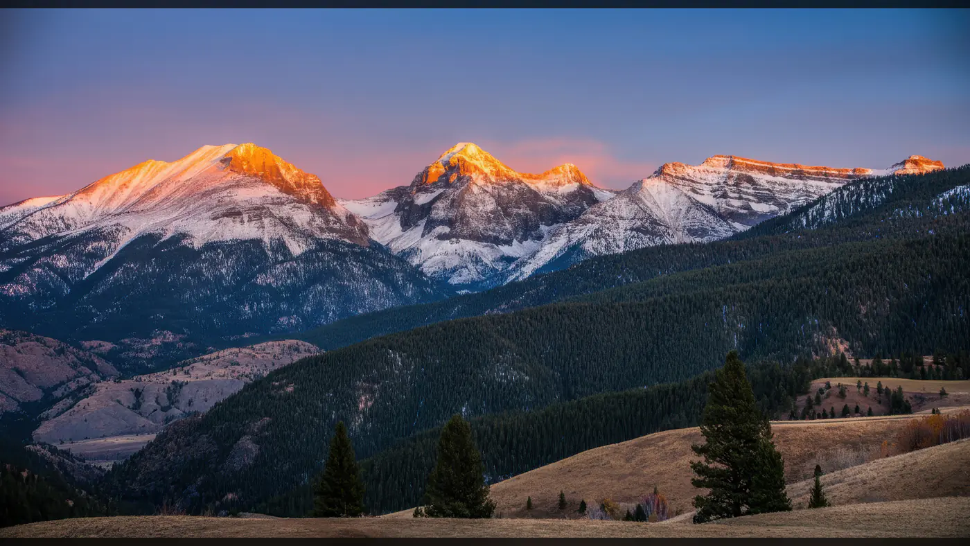 Majestic Snow-Capped Mountains at Sunrise with Forest View