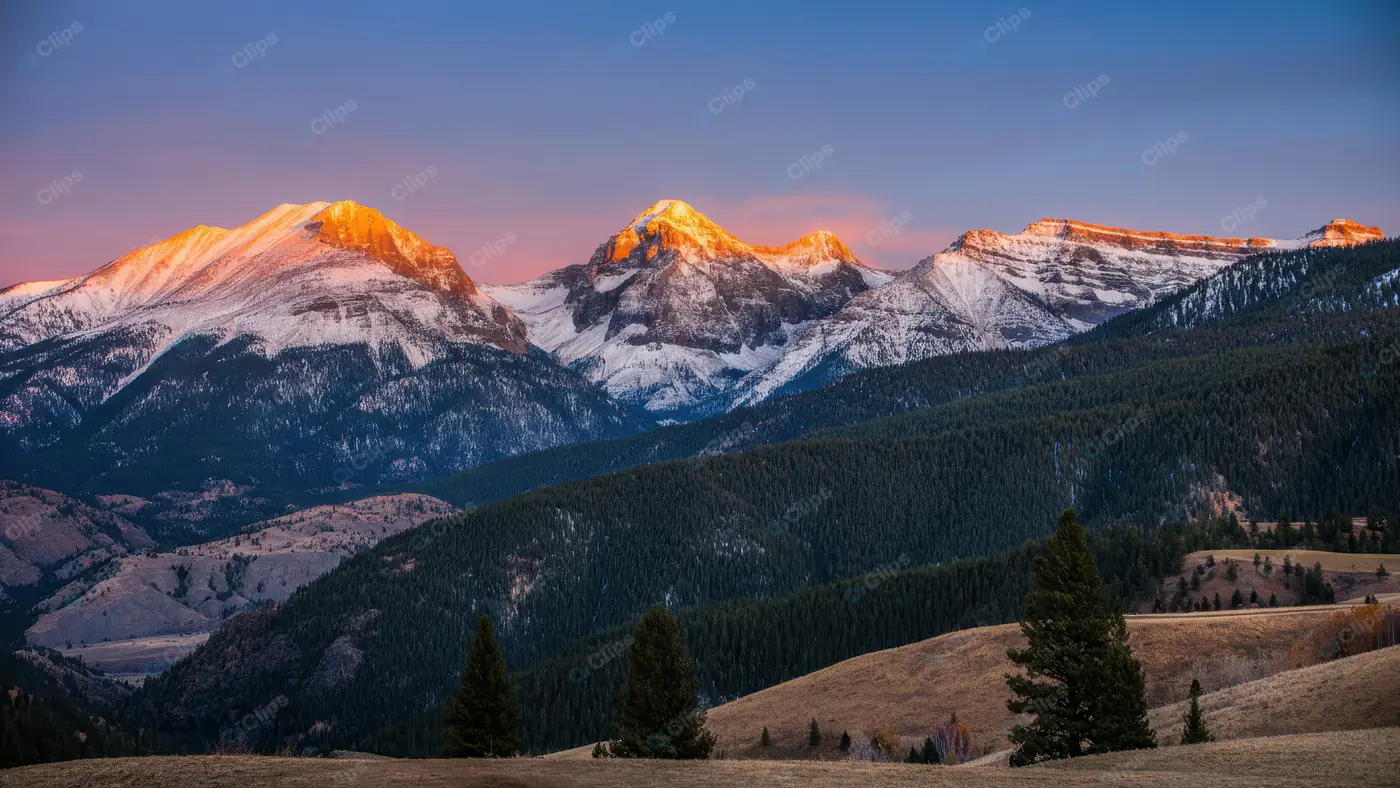 Majestic Snow-Capped Mountains at Sunrise with Forest View