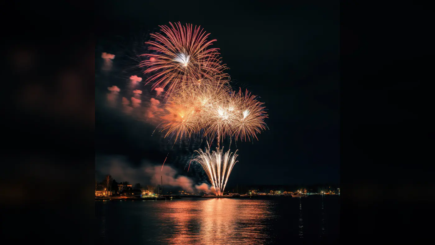 Fireworks Over Water with City Skyline at Night