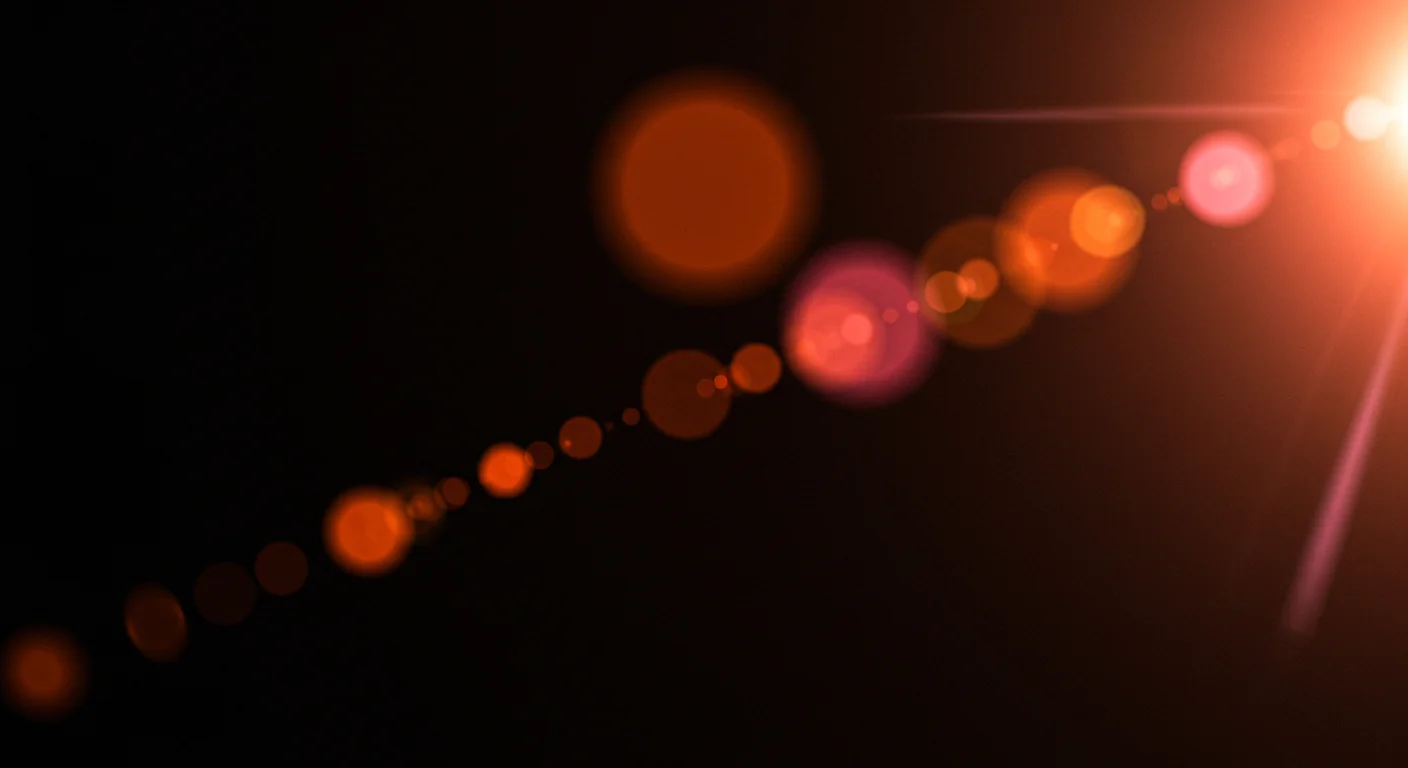Diagonal Red-Orange Lens Flare Trail with Bokeh Circles