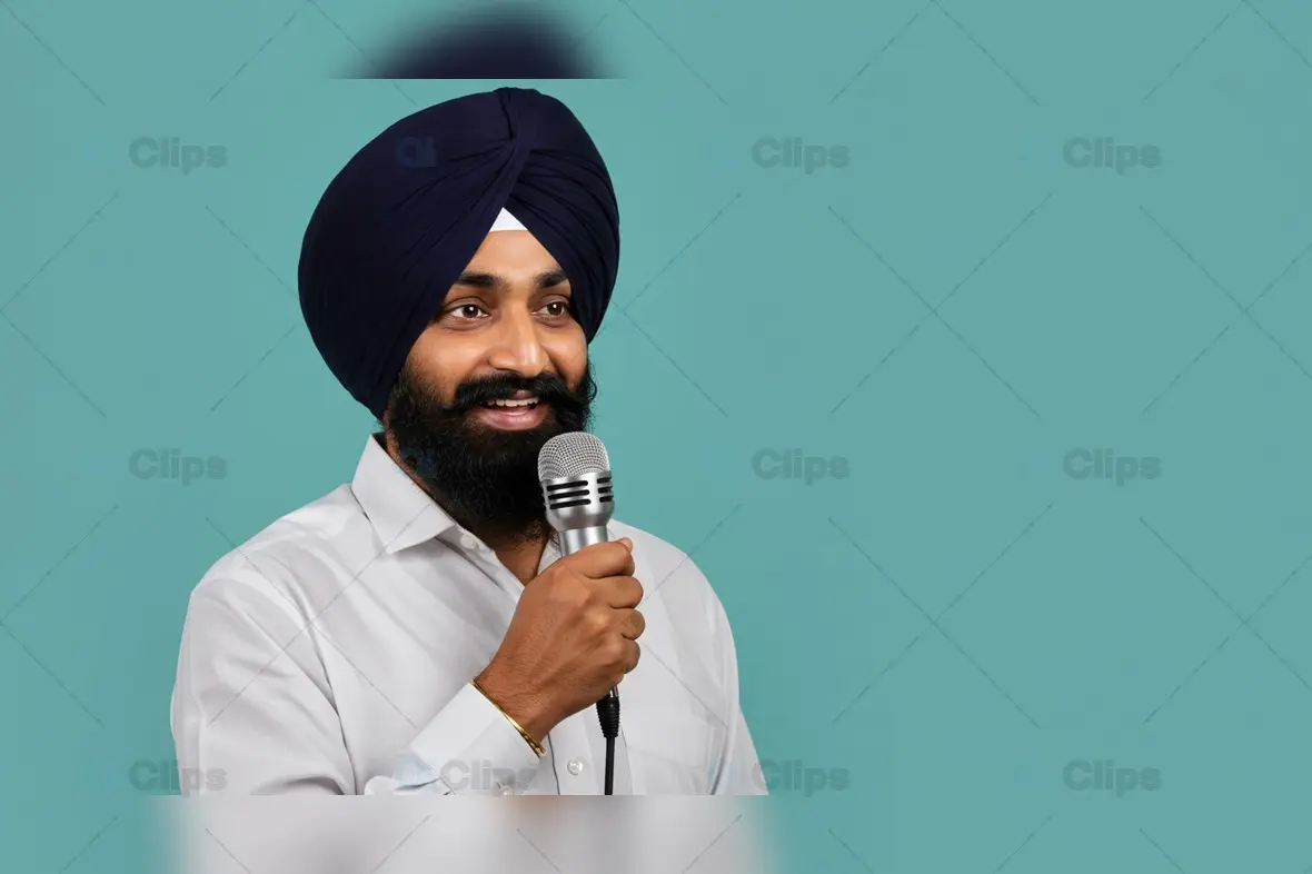 Sikh Man Speaking into Microphone on Solid Background