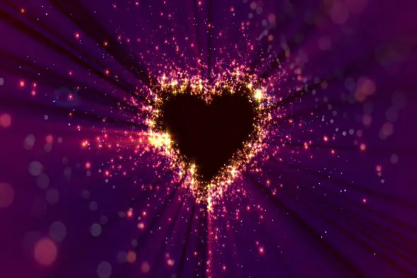 Glowing Heart Silhouette with Radiant Golden Sparkles and Light Streaks