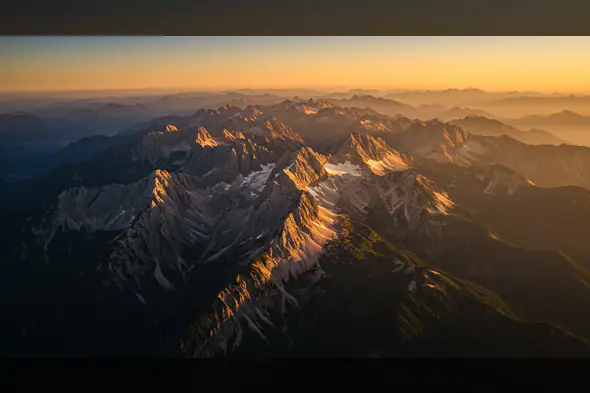 Aerial View of Majestic Mountain Range during Sunset