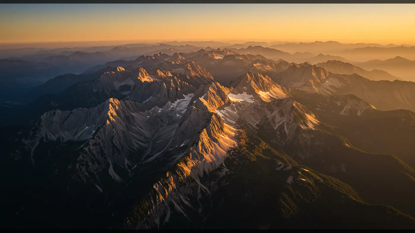 Aerial View of Majestic Mountain Range during Sunset