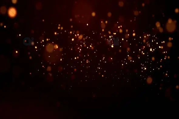 Golden Sparkling Particles on Dark Background