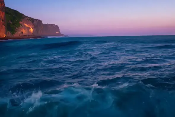 Coastal Cliffs at Twilight with Turbulent Ocean Waves