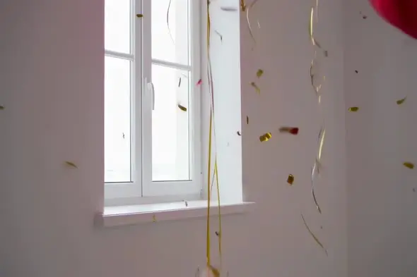 Falling Gold Confetti by Window with Natural Light