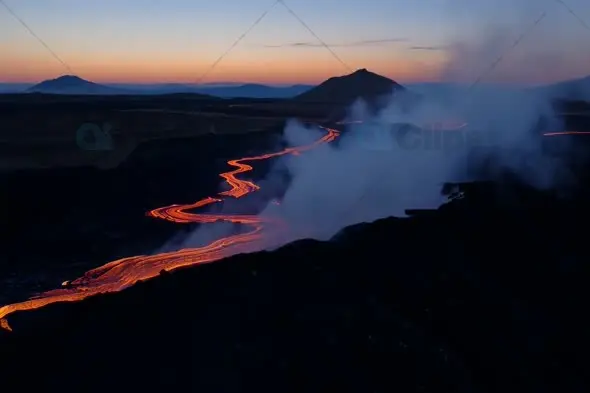 Meandering Lava Flow Through Mountain Valley at Twilight