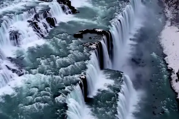 Majestic Cascading Waterfall with Turquoise Waters Aerial View