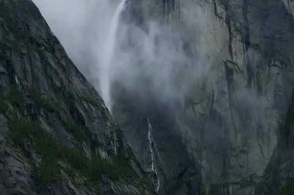 Misty Mountain Waterfall Cascading Down Dramatic Rocky Cliff