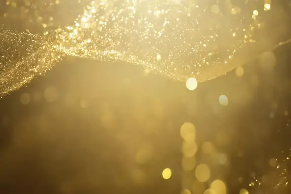 Elegant Golden Particles Flowing with Bokeh Effect
