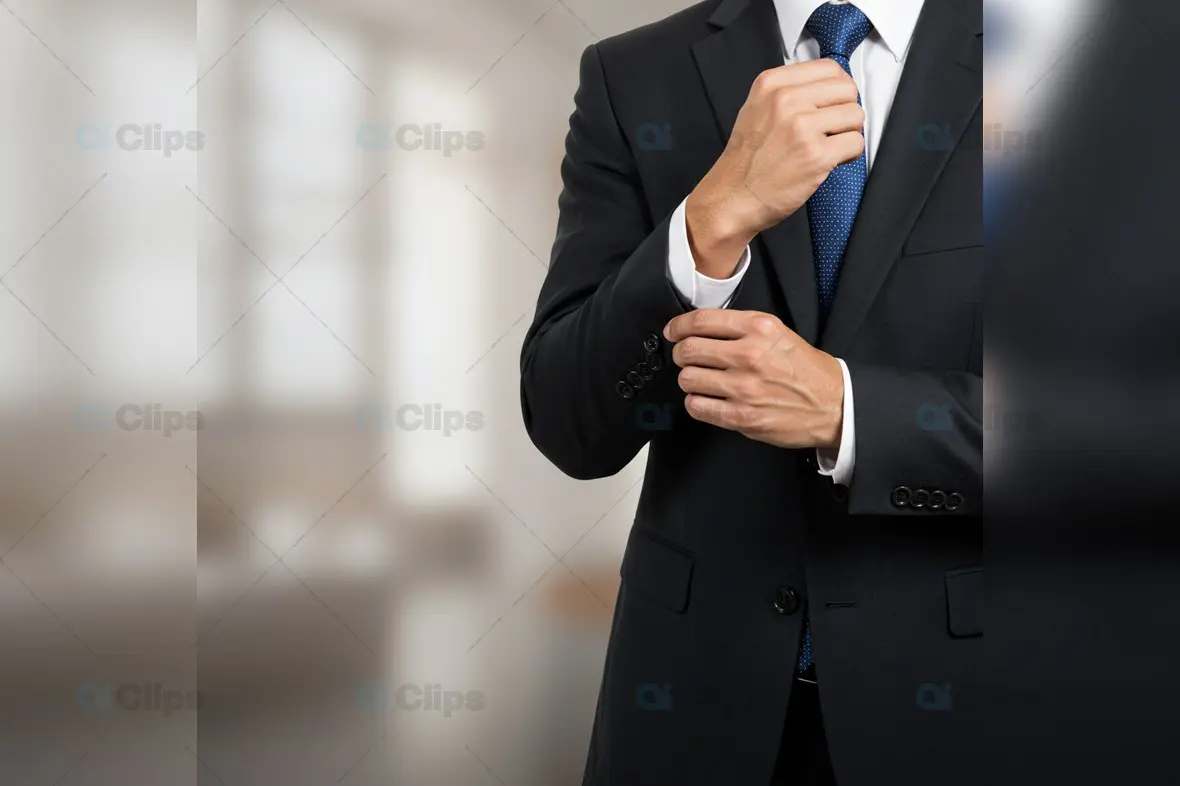 Professional Adjusting Cufflink in Black Suit with Blue Tie