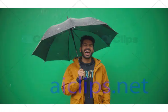 Man Laughing Under Umbrella on Rainy Day