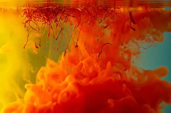 Fiery Red and Yellow Ink Swirl in Water Creating Abstract Fusion Effect