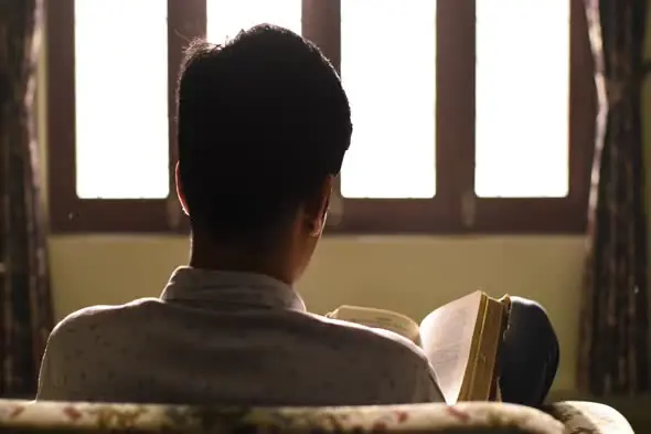 Contemplative Reader by Window