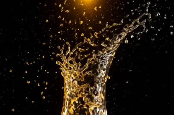 Dynamic Golden Liquid Splash Against Black Background