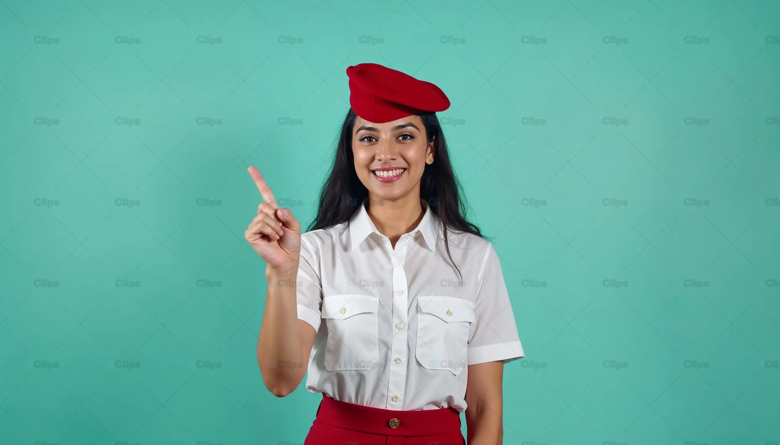 Smiling Female Airline Attendant Pointing Upwards