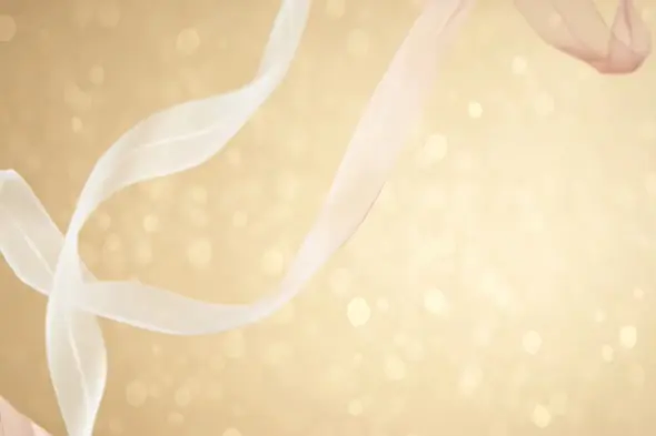 Soft Golden Ribbons Floating with Sparkling Light Background