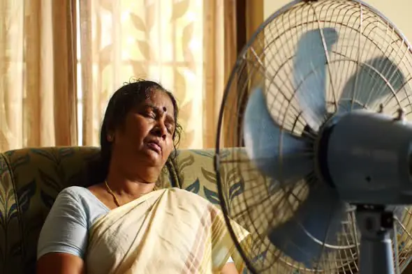 Exhausted Woman Seeking Relief from Heat