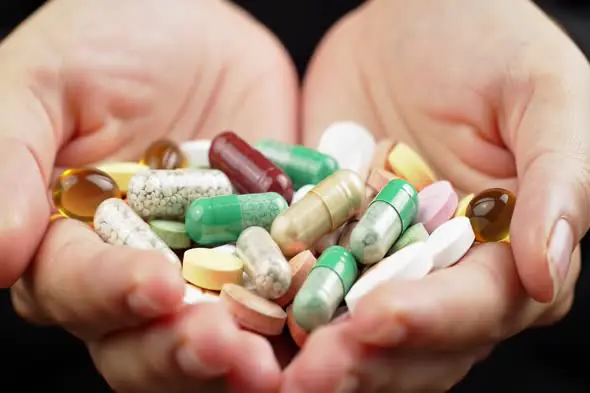 Diverse Medication Assortment in Cupped Hands
