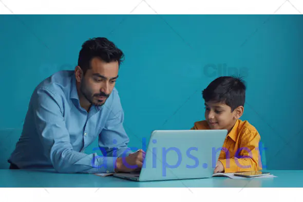 Father Helping Son with Laptop