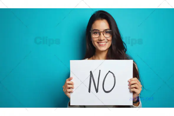 Woman Smiling Holding "No" Sign