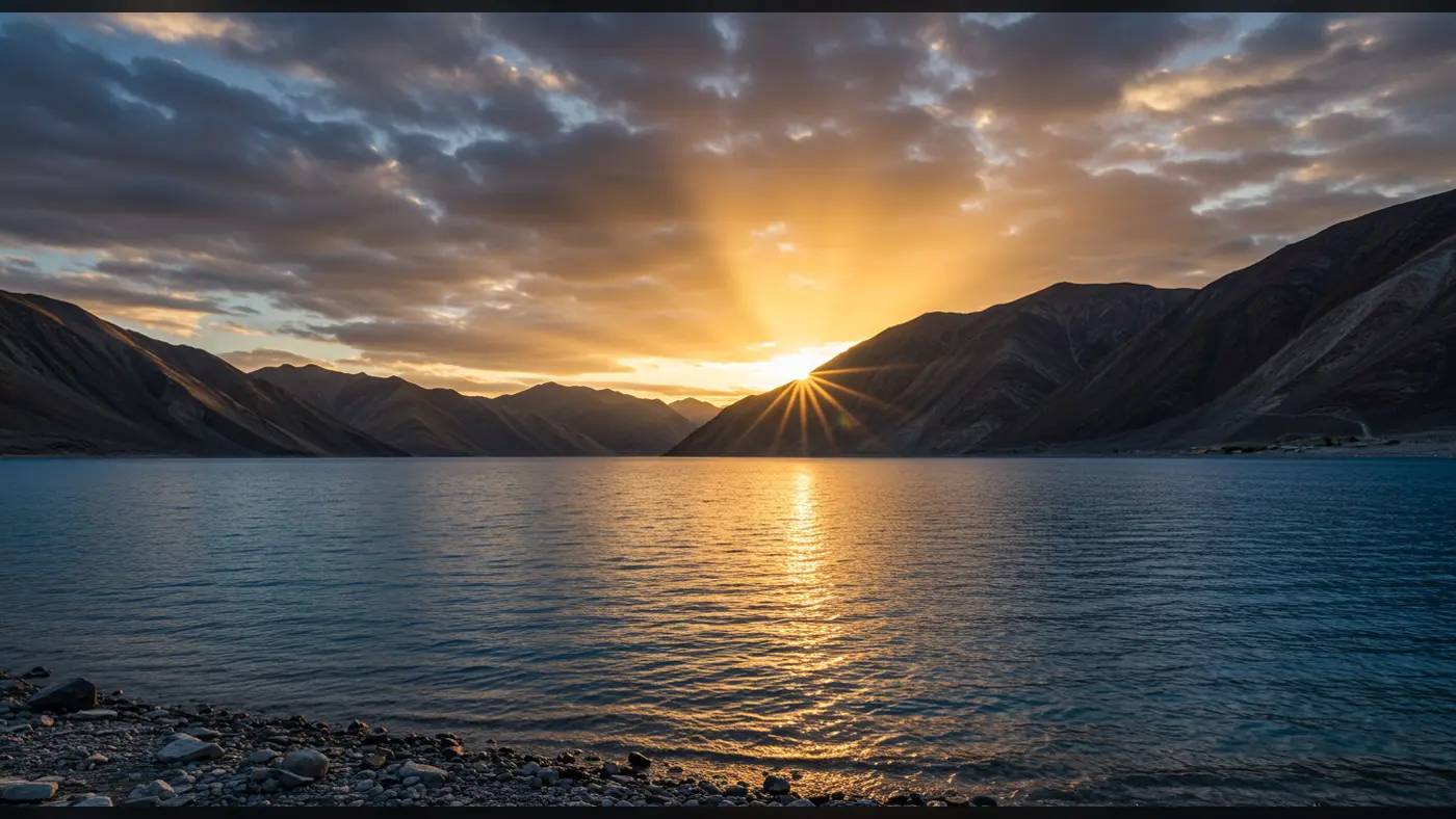 Sunset Over Mountain Lake with Golden Reflections and Dramatic Sky