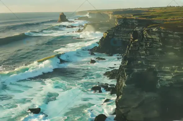 Aerial View of Rugged Coastal Cliffs and Crashing Waves