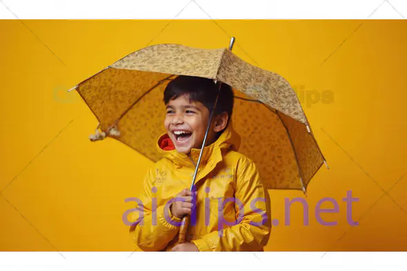 Happy Child with Umbrella on Yellow Background
