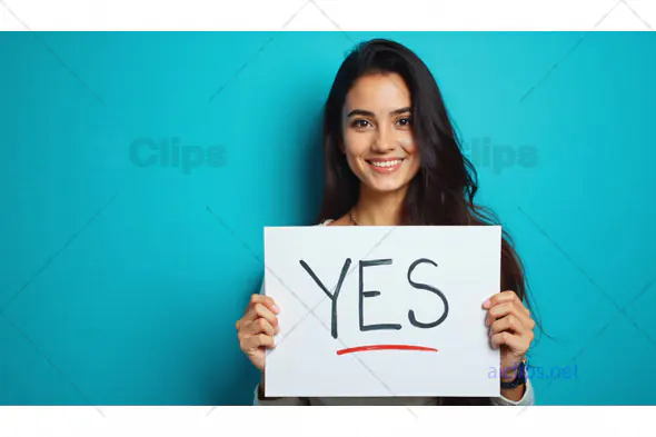Woman Smiling Holding "Yes" Sign