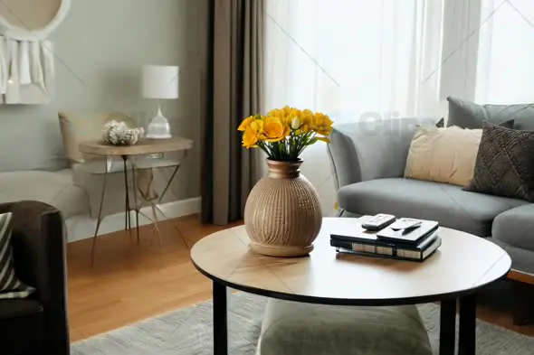 Cozy Modern Living Room with Vase of Yellow Flowers on Coffee Table