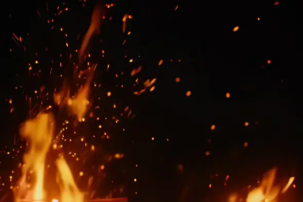 Fiery flames with sparks flying in dark background