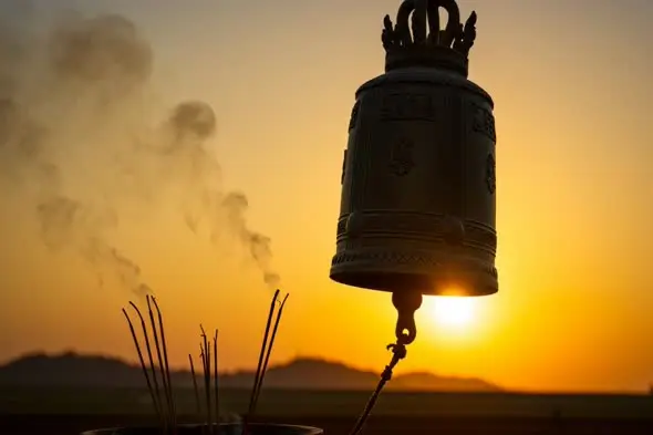 Temple bell and incense smoke at sunrise