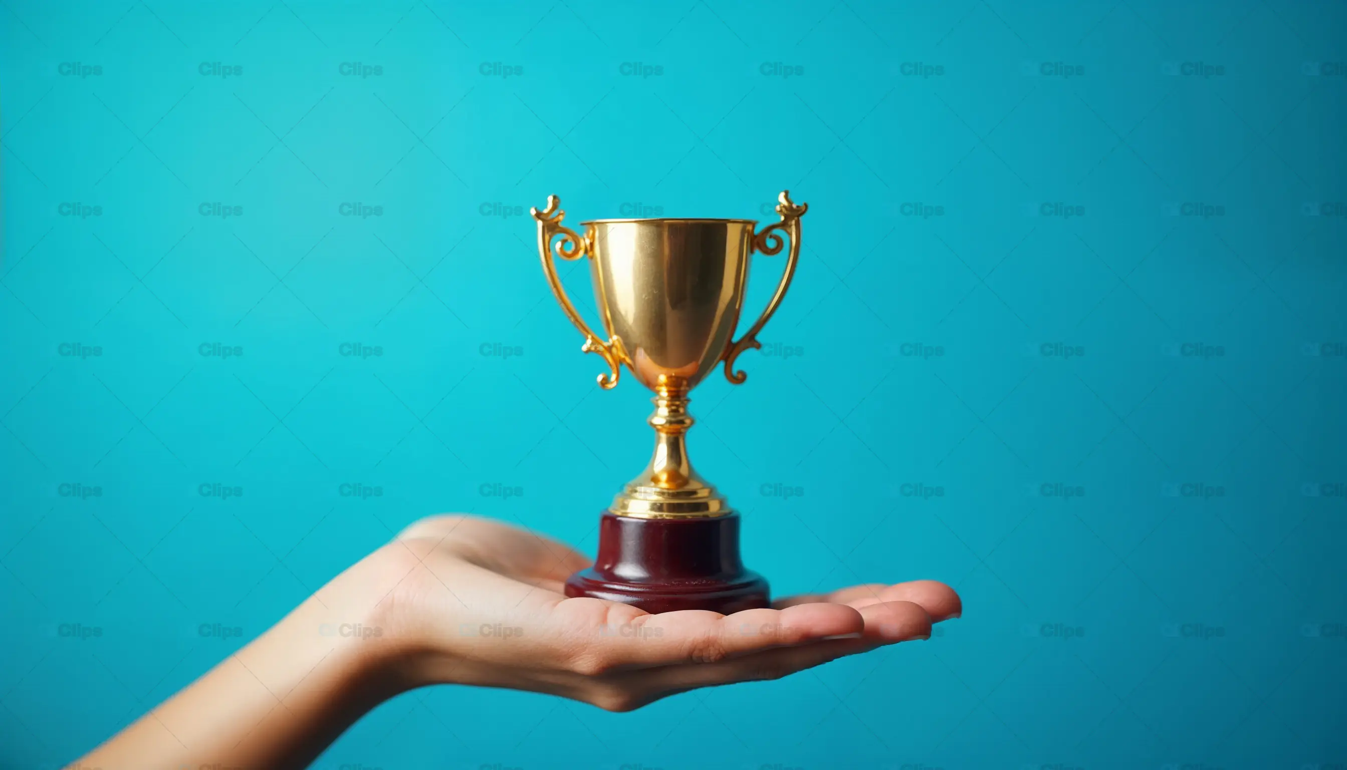 Hand Holding Golden Trophy
