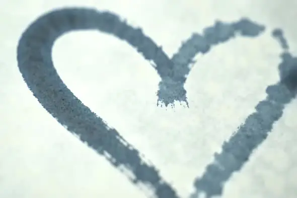 Heart Shape Drawn with Ink Bleed on Textured White Paper Background