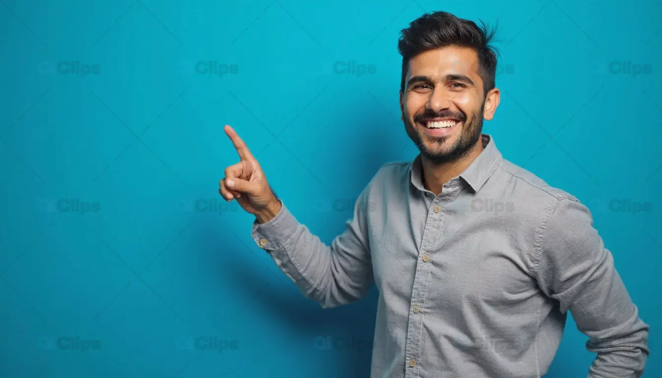 Smiling Man Pointing Upwards on Blue Background