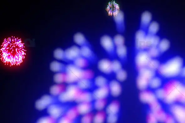 Vibrant Multicolor Fireworks Burst with Blurred Blue and Pink Explosions