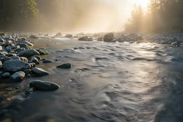 Misty River Sunrise Illuminating Rocky Landscape Scenery