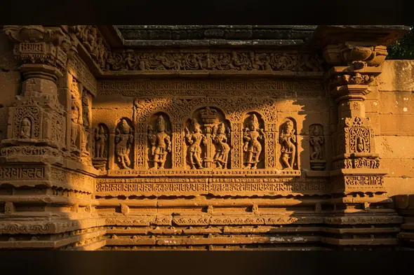 Ancient Temple Wall with Sculptures | Sunlit Indian Heritage Carvings