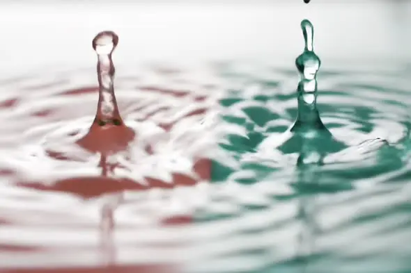 Slow Motion Water Droplet Splash with Dual Red and Green Color Effect