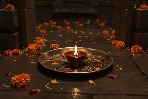 Traditional Diya with Marigold Petals in Indian Temple Ambience