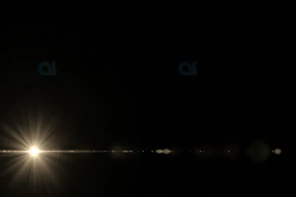 Horizontal Light Flare with Radiant Beams on Dark Background